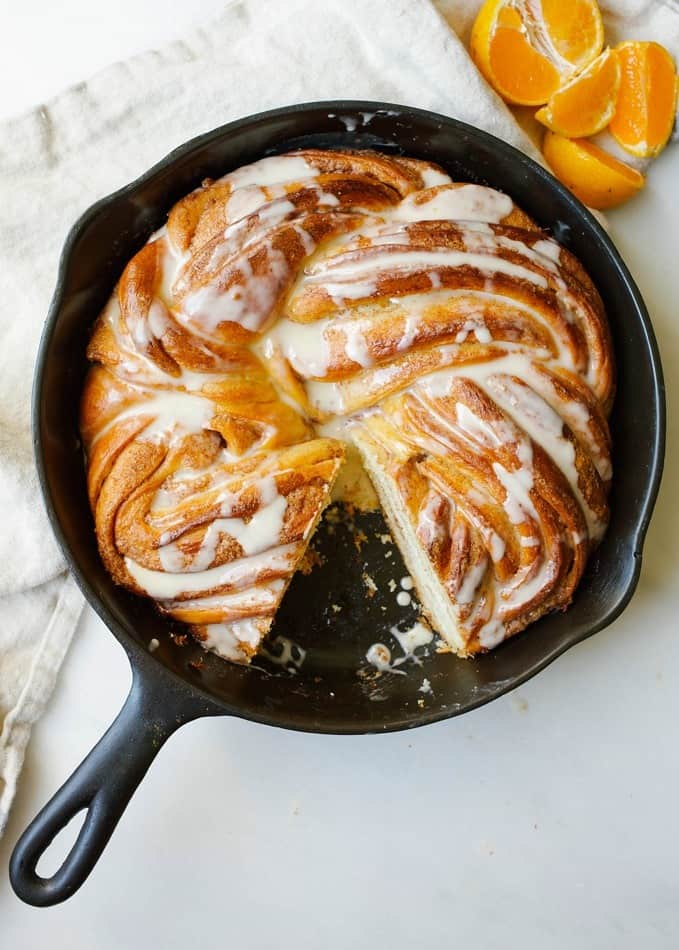 Orange Swirl Bread by Wood and Spoon blog. This is a cinnamon- swirled yeast bread twisted with orange zest and drizzled with orange glaze. Served warm, this is an excellent breakfast treat but is also perfect for nibbling on at dessert. This bread is a baking challenge and a fun way to learn more about baking! Read more about this citrus cold-weather recipe on thewoodandspoon.com by Kate Wood