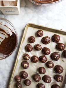 Cookie Dough Truffles by Wood and Spoon. These are eggless cookie dough balls that are dipped in melted dark chocolate and sprinkled with sea salt. The finished product are mini homemade chocolate truffles that are perfect for cookie dough lovers. Learn how simple the recipe is on thewoodandspoon.com