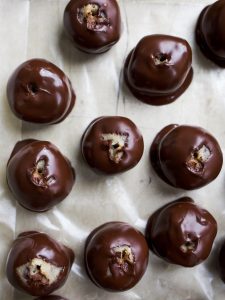 Cookie Dough Truffles by Wood and Spoon. These are eggless cookie dough balls that are dipped in melted dark chocolate and sprinkled with sea salt. The finished product are mini homemade chocolate truffles that are perfect for cookie dough lovers. Learn how simple the recipe is on thewoodandspoon.com