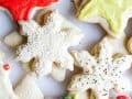 Soft Frosted Cutout Cookies recipe by Kate Wood of The Wood and Spoon blog. These are an old fashioned recipe handed down to me for soft and fluffy cutout Christmas cookies. These cookies hold their shape well and are perfect for decorating with buttercream style frosting. Host a cookie exchange or decorating party with these cookies that look great with sprinkles and other piped frosting. Find the recipe and how to for these holiday favorites on thewoodandspoon.com