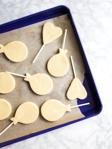 Sugar Cookie Pops by Wood and Spoon blog. These are simple, one bowl sugar cookies on lollipop sticks that Make the cutest iced alternative to cake pops! Learn how simple it is to make cutout sugar cookies with a soft glaze that isn't royal icing! Find the recipe on thewoodandspoon.com