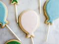 Sugar Cookie Pops by Wood and Spoon blog. These are simple, one bowl sugar cookies on lollipop sticks that Make the cutest iced alternative to cake pops! Learn how simple it is to make cutout sugar cookies with a soft glaze that isn't royal icing! Find the recipe on thewoodandspoon.com