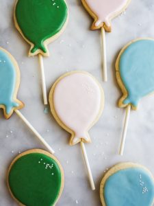 Sugar Cookie Pops by Wood and Spoon blog. These are simple, one bowl sugar cookies on lollipop sticks that Make the cutest iced alternative to cake pops! Learn how simple it is to make cutout sugar cookies with a soft glaze that isn't royal icing! Find the recipe on thewoodandspoon.com