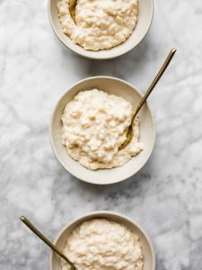 Creamy Rice Pudding by Wood and Spoon blog. Check out this copycat recipe for homemade rice pudding. This is a simple stovetop recipe requiring no bake time. The pudding is sweet cream flavored and can easily be made vanilla or cinnamon as well. Learn how to make easy homemade rice pudding on thewoodandspoon.com