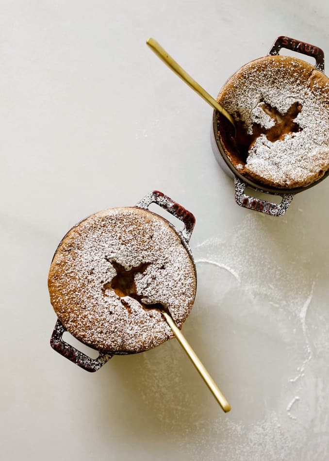 Mint Chocolate Souffles by Wood and Spoon blog. These are fluffy rich dark chocolate souffles with a mint creme anglais. From the Staub cookbook by Amanda Fredrickson. Served in mini cocottes or ramekins, these desserts are perfect for fancy or holiday dinner parties, birthdays and other special events. Find the how to on thewoodandspoon.com by Kate Wood