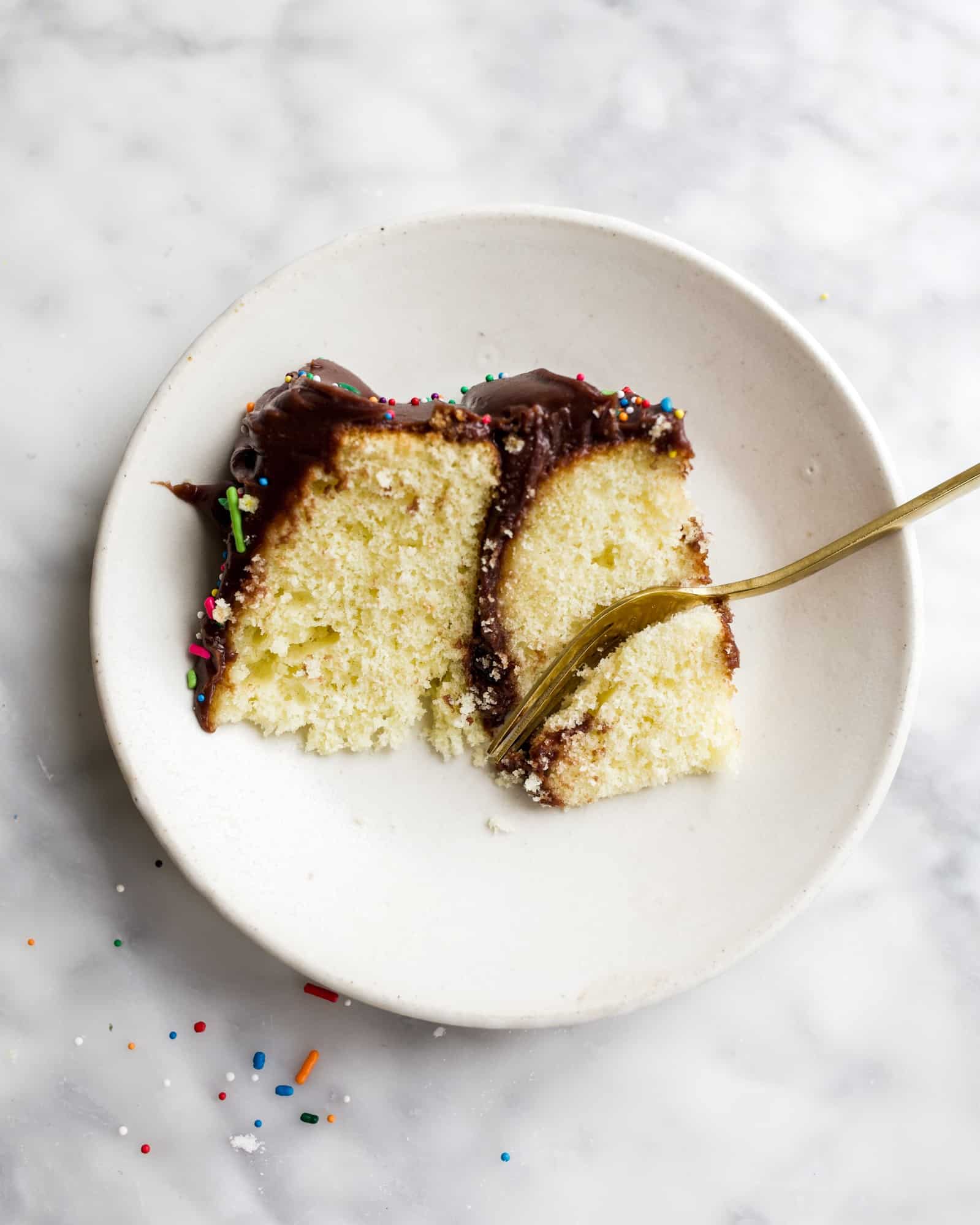 Mini Yellow Cake by Wood and Spoon blog. This tiny yellow cake is perfect for small celebrations, small batch bites, and smash cakes! Learn how simple it is to make a moist yellow cake from scratch with a fudge chocolate stovetop frosting on thewoodandspoon.com