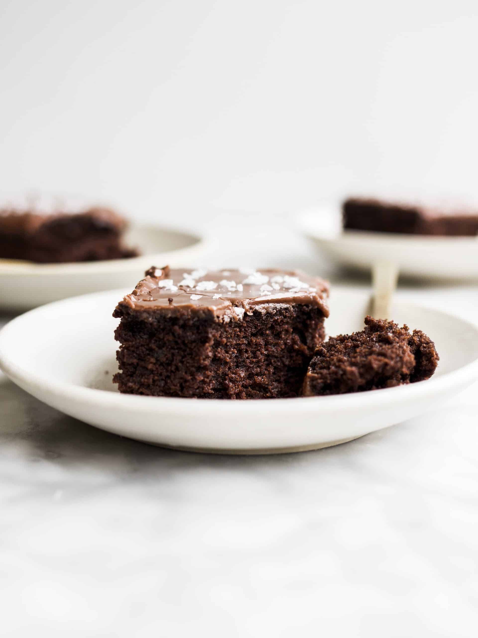 Fudgy Chocolate Sheet Cake by Wood and Spoon Blog. This is a simple recipe made without a stand mixer. The cake is scented with cocoa powder and coffee and the easy pour-on stovetop glaze makes it sweet and fudgy. A sprinkle of salt makes this crowd-pleasing dessert a little sweet and salty. Learn how simple it is to make this potluck All-star cake on thewoodandspoon.com