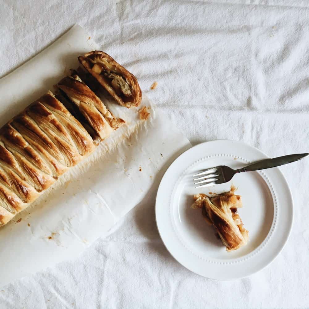 breakfast danish by the wood and spoon blog by kate wood. This is a rough puff pastry made by laminating dough, rolled out and filled with winter fruits like apples, cherries, cranberries, and other bourbon soaked fruit. Learn how to make laminated dough and how to braid a danish dough. Turns into golden, flaky, pastry once baked. Recipe at thewoodandspoon.com