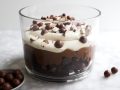 Malted Chocolate Trifle with Coffee Whipped Cream by Wood and Spoon blog. This is a simple layered brownie and chocolate pudding trifle decorated with malted chocolate balls and a coffee Kahlua whipped cream. You can simplify this recipe even more by using a boxed brownie or pudding recipe, but this homemade version of box brownies and chocolate pudding mix is so quick and easy! Learn how to make this great Easter dessert that serves a crowd on thewoodandspoon.com