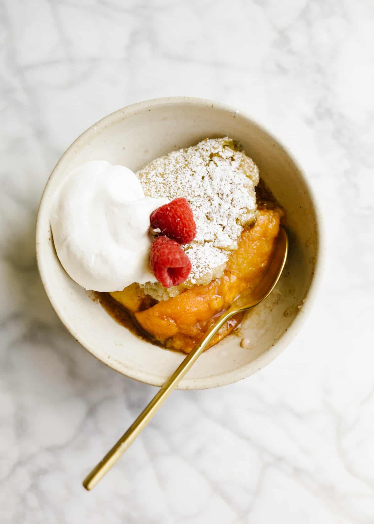 Skillet Fruit Pancake by Wood and Spoon. Similar to a breakfast cobbler, this morning treat features baked sugared fruit underneath a golden fluffy pancake. The dish serves a few and is best topped with whipped cream or a dusting of powdered sugar. Substitute in your favorite seasonal fresh or frozen fruit to enjoy! Find out more about the recipe on thewoodandspoon.com