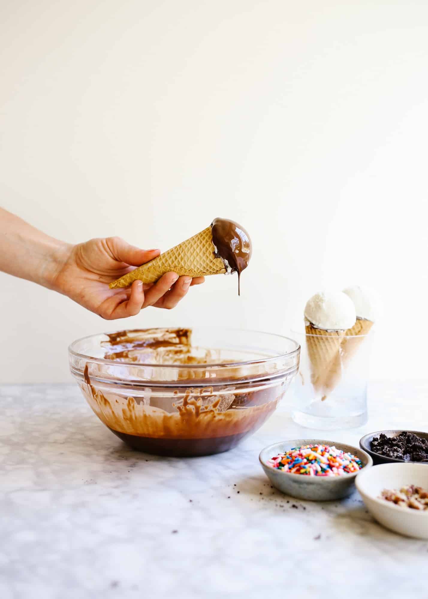 Homemade Ice Cream Drumsticks by Wood and Spoon blog. Learn how to make novelty ice cream treats with chocolate magic shell filling, ice cream scoops of choice, and a wide variety of unique toppings! The recipe is make ahead and perfect for summer treats, kids parties, and poolside desserts. Learn how to make a DIY version of these grocery store faves on thewoodandspoon.com