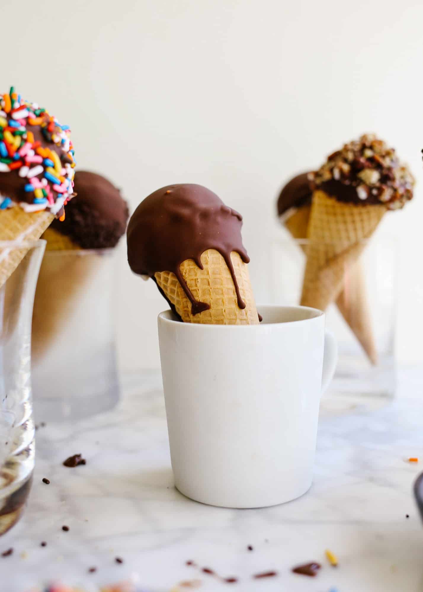 Homemade Ice Cream Drumsticks by Wood and Spoon blog. Learn how to make novelty ice cream treats with chocolate magic shell filling, ice cream scoops of choice, and a wide variety of unique toppings! The recipe is make ahead and perfect for summer treats, kids parties, and poolside desserts. Learn how to make a DIY version of these grocery store faves on thewoodandspoon.com