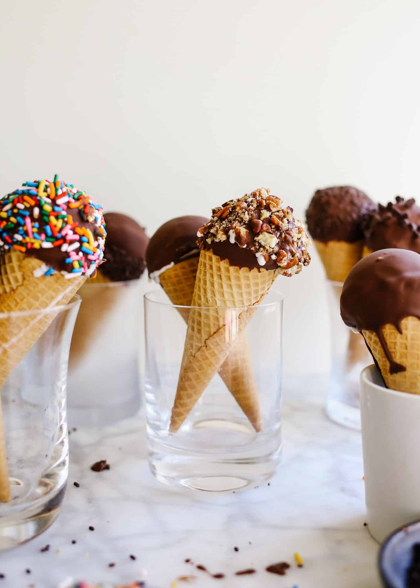 Homemade Ice Cream Drumsticks by Wood and Spoon blog. Learn how to make novelty ice cream treats with chocolate magic shell filling, ice cream scoops of choice, and a wide variety of unique toppings! The recipe is make ahead and perfect for summer treats, kids parties, and poolside desserts. Learn how to make a DIY version of these grocery store faves on thewoodandspoon.com