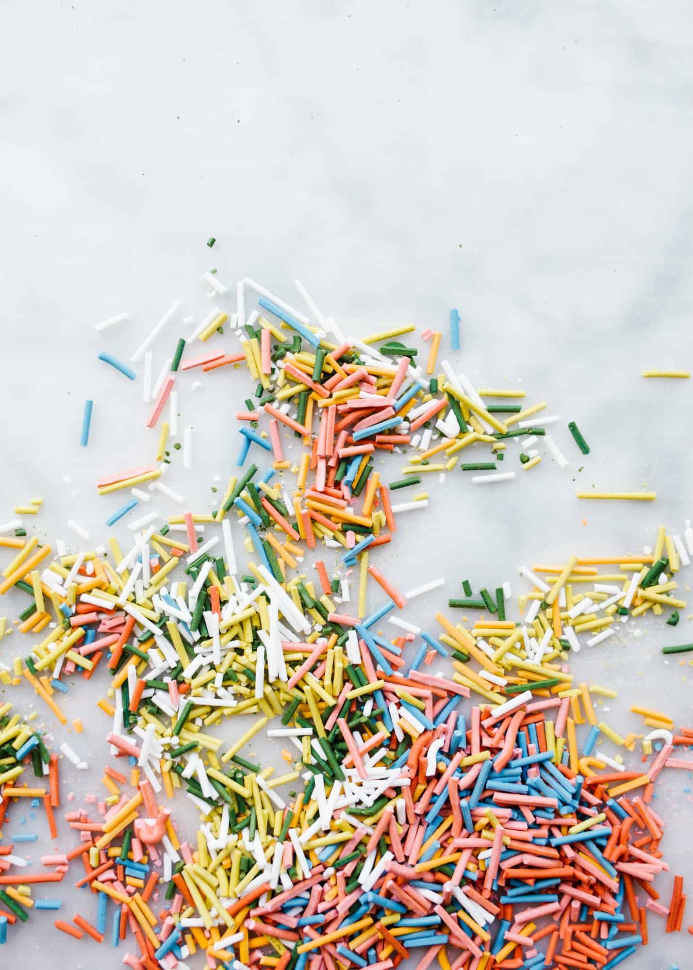 Homemade Sprinkles by Wood and Spoon blog. Here's the how to on making sprinkles from scratch! Follow one of three ways to make hand-dyed jimmies, nonpareils, and flaked sugar confetti. Use these edible decorations to glitter cakes, cookies, cupcakes and more! Find the recipes and learn DIY from scratch here on thewoodandspoon.com