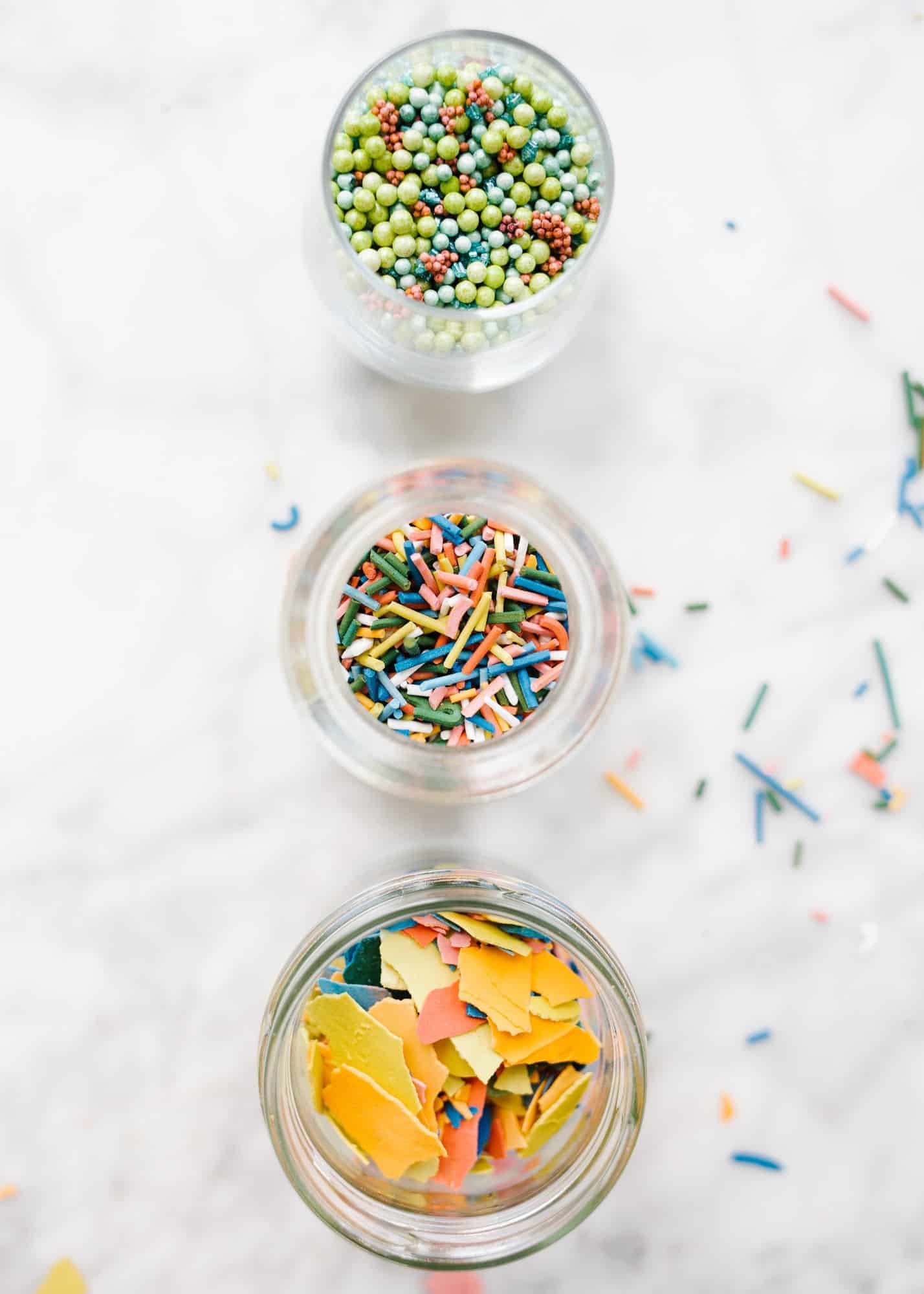 Homemade Sprinkles by Wood and Spoon blog. Here's the how to on making sprinkles from scratch! Follow one of three ways to make hand-dyed jimmies, nonpareils, and flaked sugar confetti. Use these edible decorations to glitter cakes, cookies, cupcakes and more! Find the recipes and learn DIY from scratch here on thewoodandspoon.com