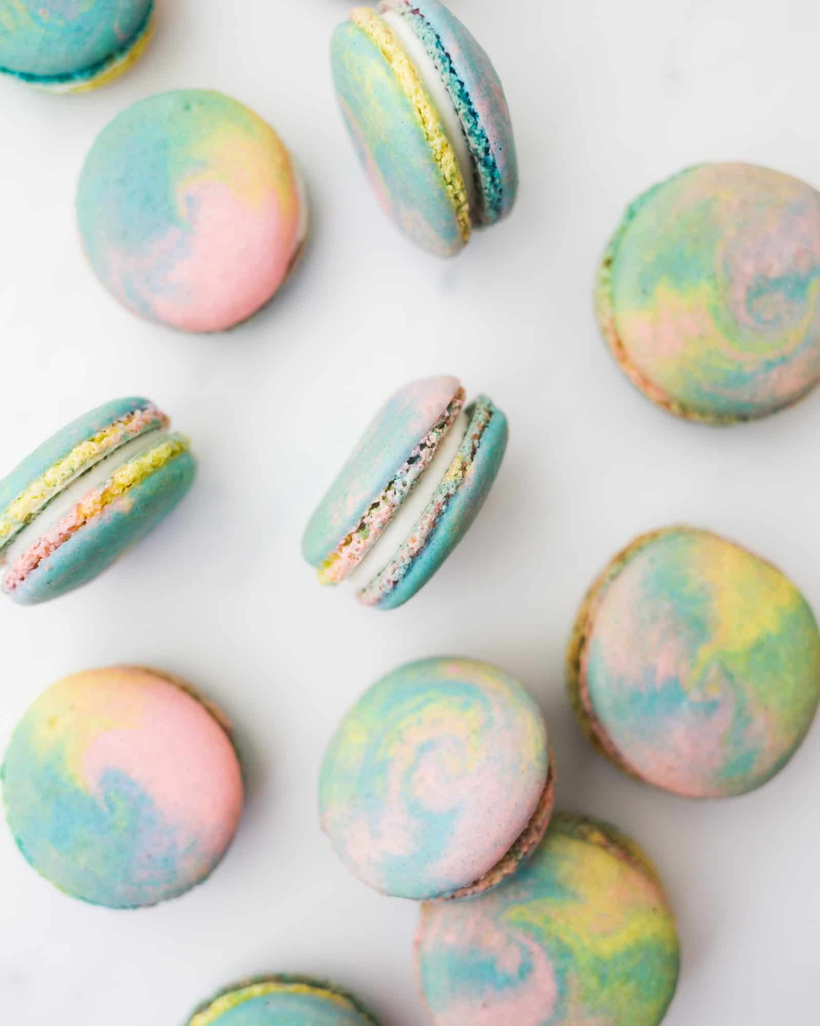 Tie Dye Macarons by Wood and Spoon blog. This is a simple tutorial for colorful swirled macarons. Learn how to make homemade French macarons with a simple buttercream filling. The recipe and tutorial with photos is here on thewoodandspoon.com !