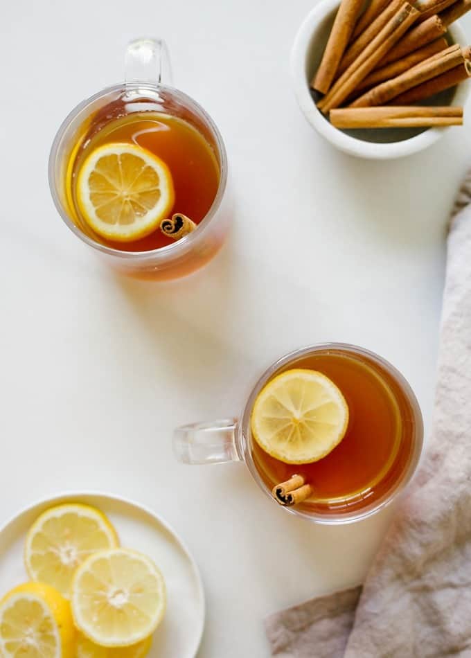 Sweet Tea Hot Toddy recipe by Wood and spoon blog. This is a bourbon, lemon, cinnamon and honey cocktail sweetened with pre made red diamond sweet tea. A southern take on the classic cocktail. Serve it warm for a refreshingly cozy holiday winter beverage. Make for a crowd for parties too! Read more at thewoodandspoon.com