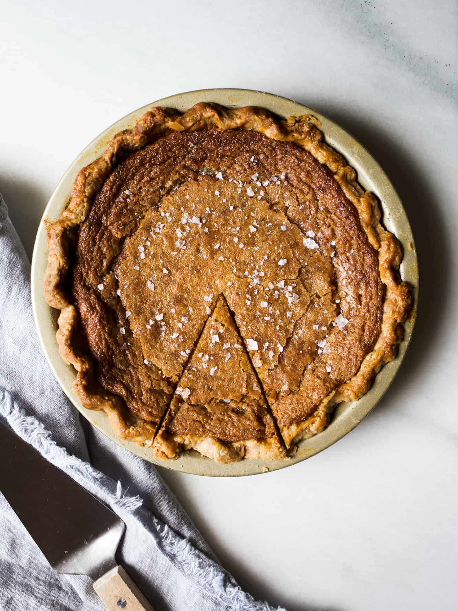 Salted Maple Pie by Wood and Spoon. This is a decadent chess pie recipe from Sister Pie in Detroit! Made with eggs, maple syrup, and a buttery flaky crust, this pie is a sweet and salty lover's dream! Perfect for the fall and holidays, this pie would be at home on any Thanksgiving table. Find the recipe and how to for par-baking crust and knowing when this pie is done on thewoodandspoon.com by Kate wood.