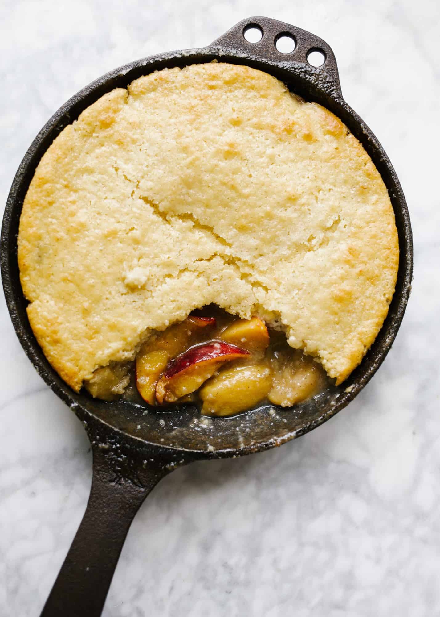 Skillet Fruit Pancake by Wood and Spoon. Similar to a breakfast cobbler, this morning treat features baked sugared fruit underneath a golden fluffy pancake. The dish serves a few and is best topped with whipped cream or a dusting of powdered sugar. Substitute in your favorite seasonal fresh or frozen fruit to enjoy! Find out more about the recipe on thewoodandspoon.com