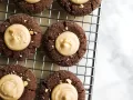 Inside-Out Peanut Butter Blossoms by Kate Wood of Wood and Spoon. These are chewy chocolate thumbprint cookies filled with a peanut butter cup filling. These cookies are the perfect Christmas cookie to make for the peanut butter lovers in your life this holiday season. Learn how and read about the recipe on thewoodandspoon.com