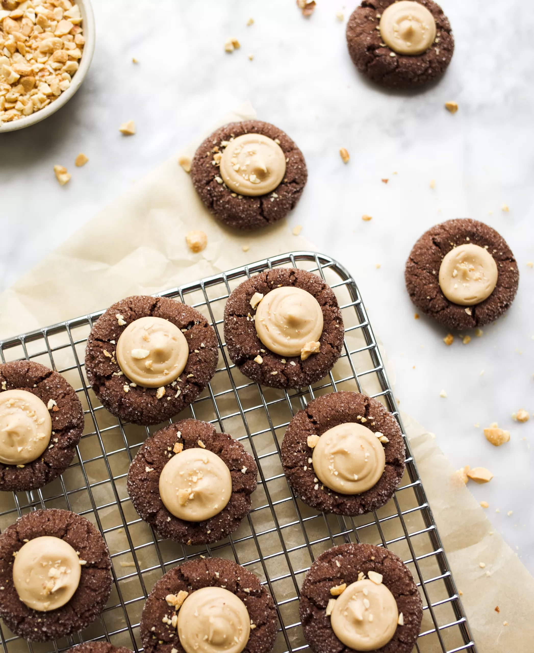 Inside-Out Peanut Butter Blossoms by Kate Wood of Wood and Spoon. These are chewy chocolate thumbprint cookies filled with a peanut butter cup filling. These cookies are the perfect Christmas cookie to make for the peanut butter lovers in your life this holiday season. Learn how and read about the recipe on thewoodandspoon.com