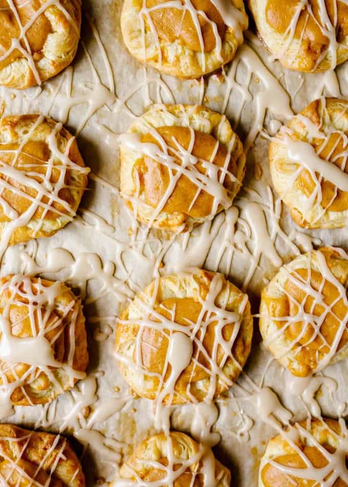 Pumpkin Danishes Recipe by Wood and Spoon. These are fluffy buttery pastries with a simple pumpkin filling and a brown butter glaze. Each danish is small and each batch makes enough to share with a crowd. These are flavored with fall spices and make a really special autumn breakfast baked good. Find the recipe and how to for these danishes on thewoodandspoon.com by Kate Wood.