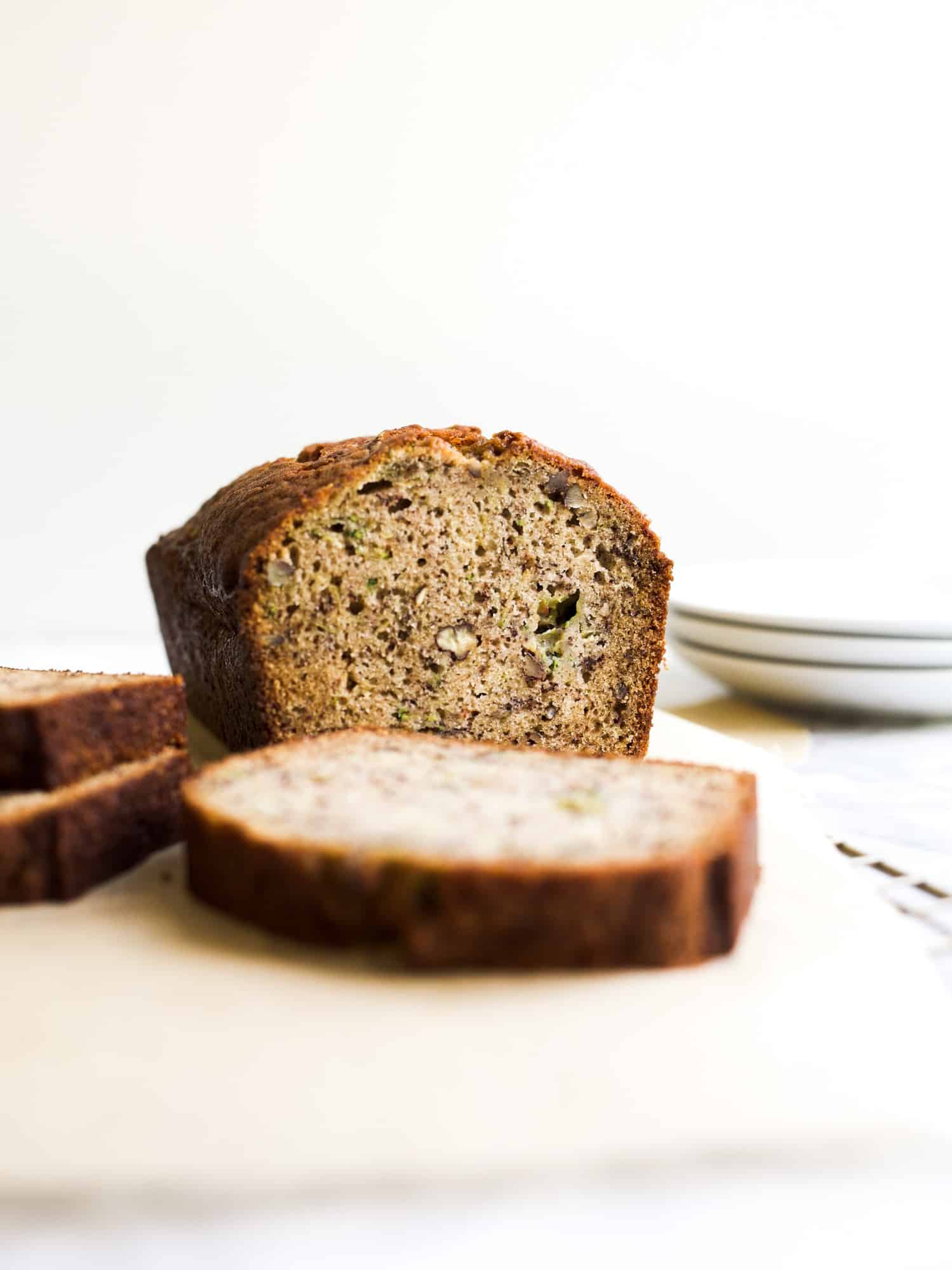 Easy Zucchini Banana Bread by Wood and Spoon blog. My favorite way to use up ripe bananas and summer zucchini is this quick bread! Served with a simple whipped cream cheese butter and loaded with pecans, bananas, cinnamon, and fresh zucchini, this bread is a delicious breakfast or snack treat! find the recipe and how to on thewoodandspoon.com