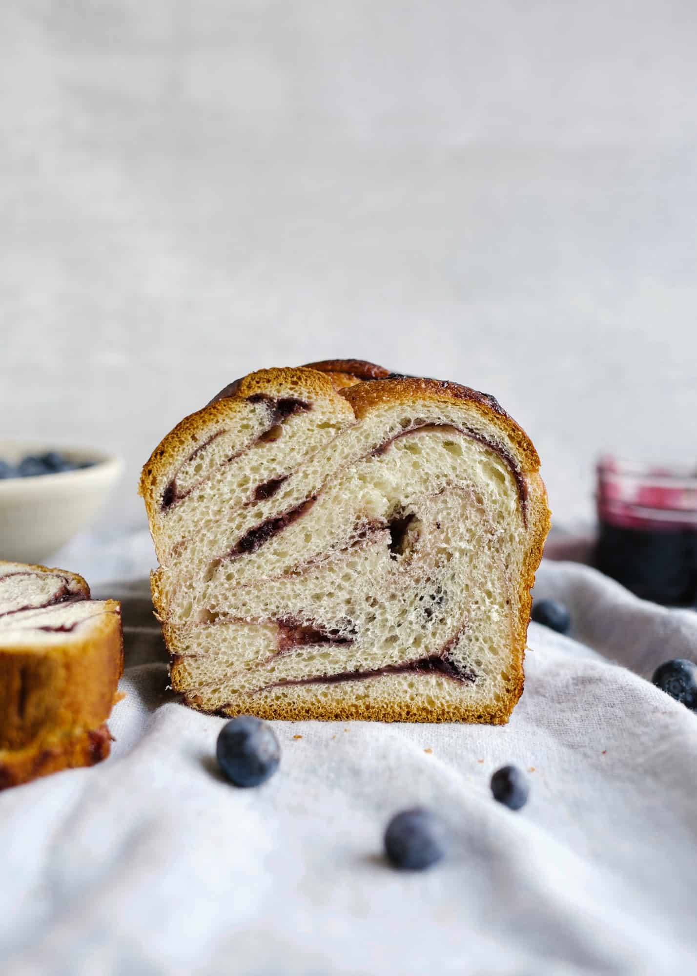 Blueberry Babka recipe by Wood and Spoon. This is a butter filled braided yeast loaf filled with a blueberry lemon and cinnamon swirl jam. The loaves are twisted and bake into wonderful toasting bread. Find the recipe for this fresh summer baked good on thewoodandspoon.com by Kate Wood