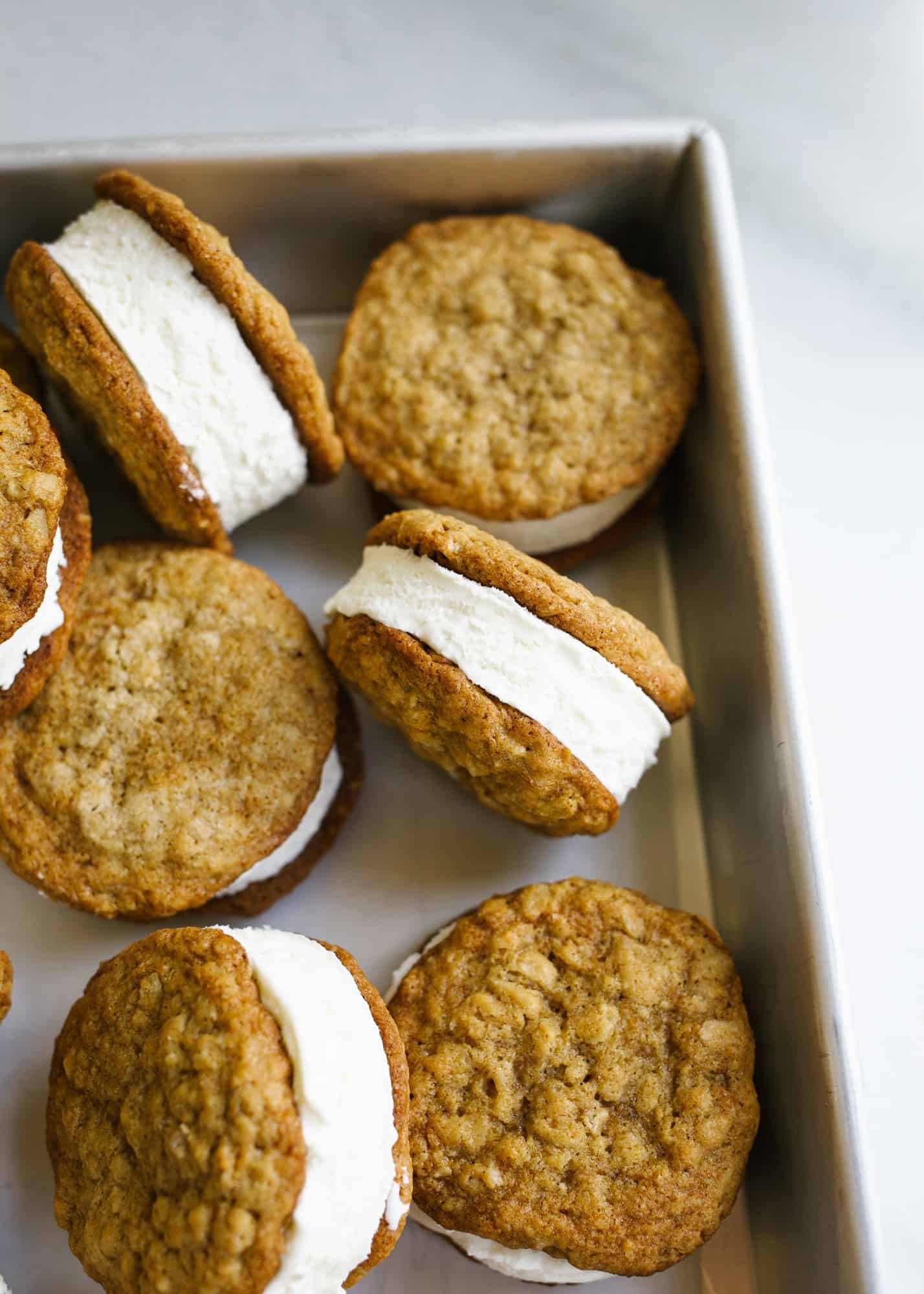 Oatmeal Cream Pie Ice Cream Sandwiches by Wood and Spoon blog. These are a frozen version of the traditional store bought cookie sandwiches made with chewy thin oatmeal cookies and filled with a no-churn marshmallow ice cream. The ice cream comes together with three ingredients including marshmallow fluff and the cookies stay soft even when frozen! Learn more about this treat and how to make homemade frozen ice cream sandwiches on thewoodandspoon.com