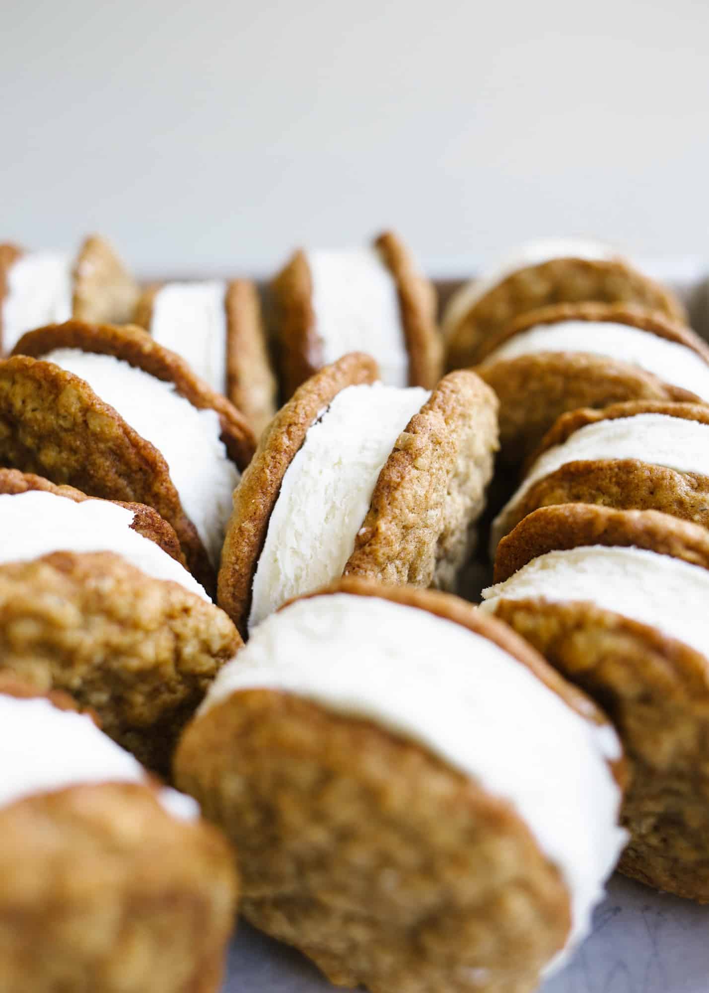 Oatmeal Cream Pie Ice Cream Sandwiches by Wood and Spoon blog. These are a frozen version of the traditional store bought cookie sandwiches made with chewy thin oatmeal cookies and filled with a no-churn marshmallow ice cream. The ice cream comes together with three ingredients including marshmallow fluff and the cookies stay soft even when frozen! Learn more about this treat and how to make homemade frozen ice cream sandwiches on thewoodandspoon.com