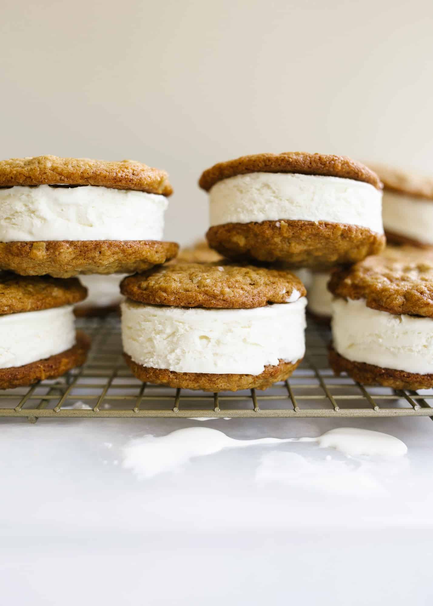 Oatmeal Cream Pie Ice Cream Sandwiches by Wood and Spoon blog. These are a frozen version of the traditional store bought cookie sandwiches made with chewy thin oatmeal cookies and filled with a no-churn marshmallow ice cream. The ice cream comes together with three ingredients including marshmallow fluff and the cookies stay soft even when frozen! Learn more about this treat and how to make homemade frozen ice cream sandwiches on thewoodandspoon.com