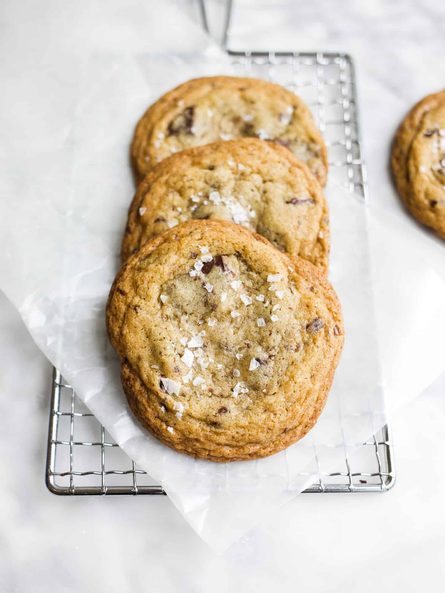 The Best Salted Chocolate Chip Cookies by Wood and Spoon Blog. These easy chocolate chip cookies have chewy insides and crisp edges. The addition of flaked salt balances the sweet making these dark chocolate chunk cookies the perfect recipe ever. Find out how to make them on thewoodandspoon.com