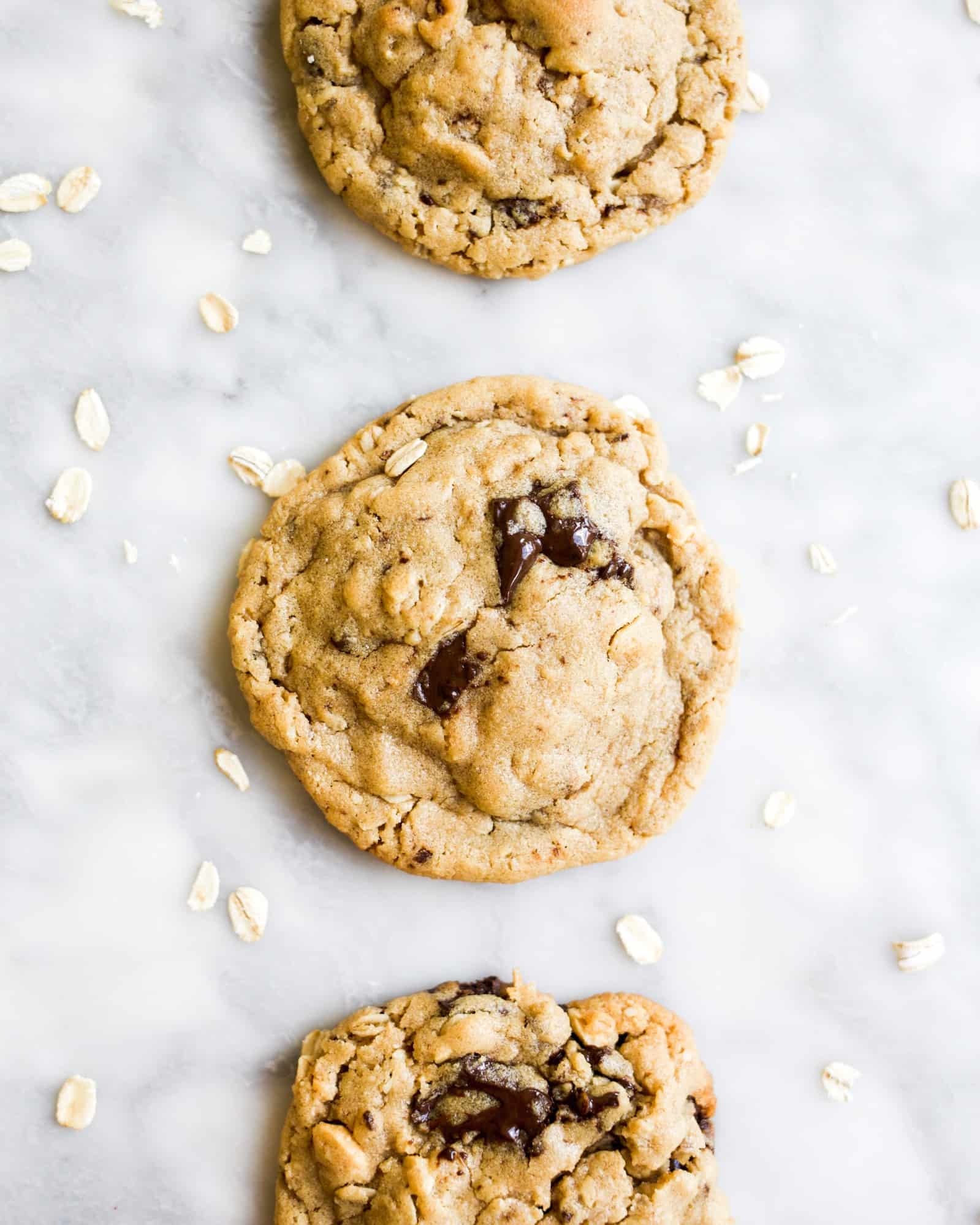 Peanut Butter Chocolate Chunk Cookies by Wood and Spoon Blog by Kate Wood. This is a thick and chewy cookie flavored with peanut butter, roasted peanuts, and semisweet or dark chocolate chunks. Oatmeal gives these cookies an extra chewy inside. These cookies freeze well and can be made ahead and are healthier because of added protein from nut butter and fiber from oats. Find the recipe on thewoodandspoon.com