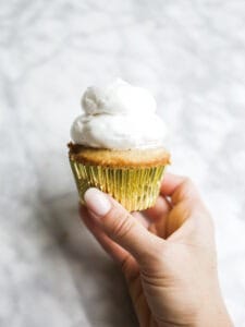 S'mores Hi-Hat Cupcakes by Wood and Spoon blog. These are graham cracker cupcakes topped with a marshmallow topping and dipped in a milk chocolate shell. These cupcakes taste like s'mores and are a beautiful way to feature chocolate magic shell. Learn how to make them on thewoodandspoon.com