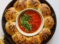 Cheesy Dinner Rolls with Tomato Dipping Sauce recipe by wood and spoon. These are soft and fluffy yeast rolls filled with gooey mozzarella cheese. Baked in a skillet and topped with italian herbs and cheese, these rolls serve as a great appetizer, side dish, and more! Make your holiday bread bowls extra delicious with these stuffed yeast breads! Check it out on thewoodandspoon.com