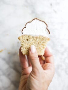 S'mores Hi-Hat Cupcakes by Wood and Spoon blog. These are graham cracker cupcakes topped with a marshmallow topping and dipped in a milk chocolate shell. These cupcakes taste like s'mores and are a beautiful way to feature chocolate magic shell. Learn how to make them on thewoodandspoon.com