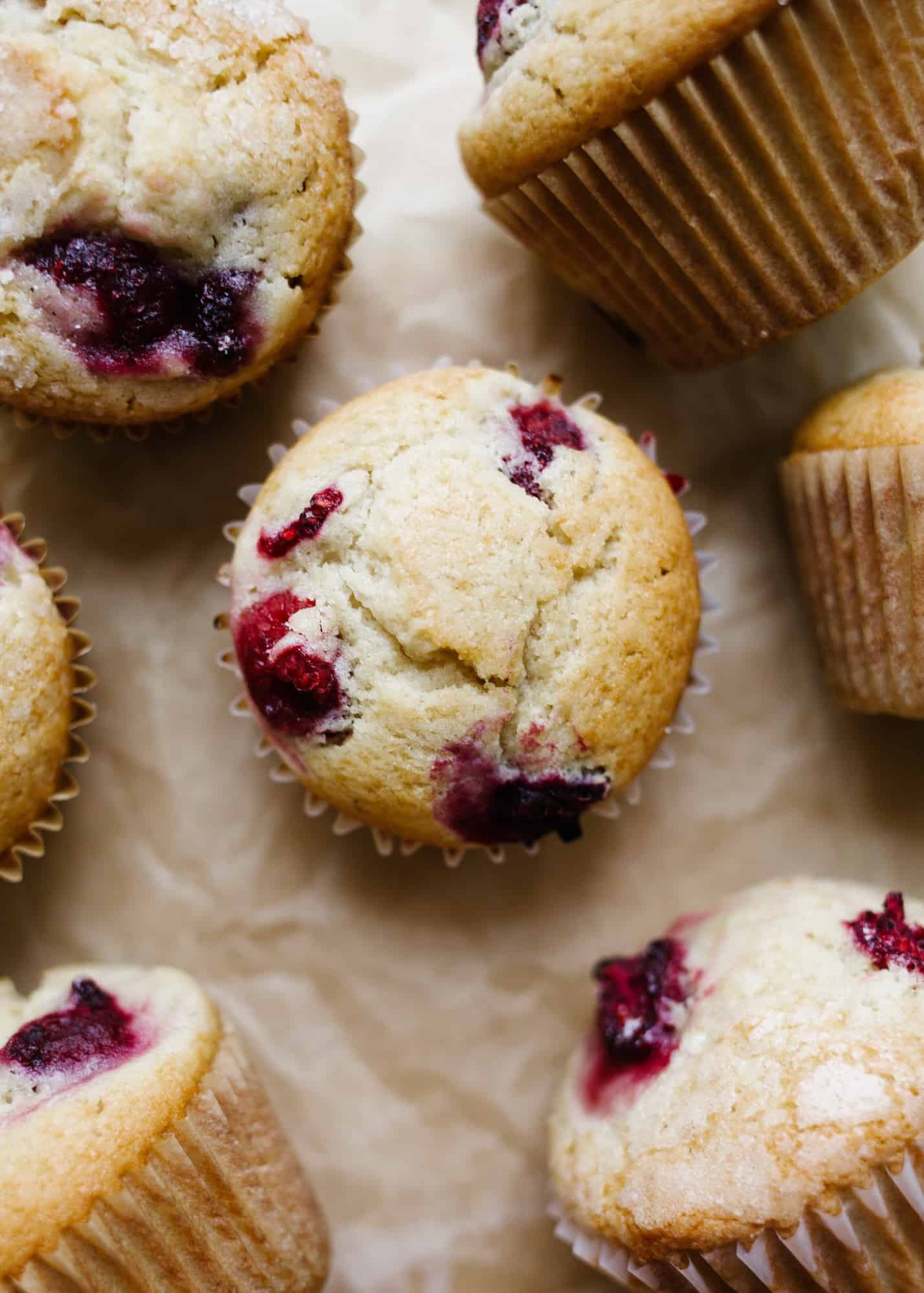 Raspberry Muffins by Wood and Spoon blog. These are fluffy, soft, maple syrup-sweetened muffins loaded with fresh raspberries or berries of your choice. The muffin uses butter for flavor, oil for moisture, and loads of complex and sweet syrup for sweetening. Add an extra layer of sugar for a crisp, caramelized top and enjoy these breakfast pastries all day long. Favorite morning sweets on thewoodandspoon.com