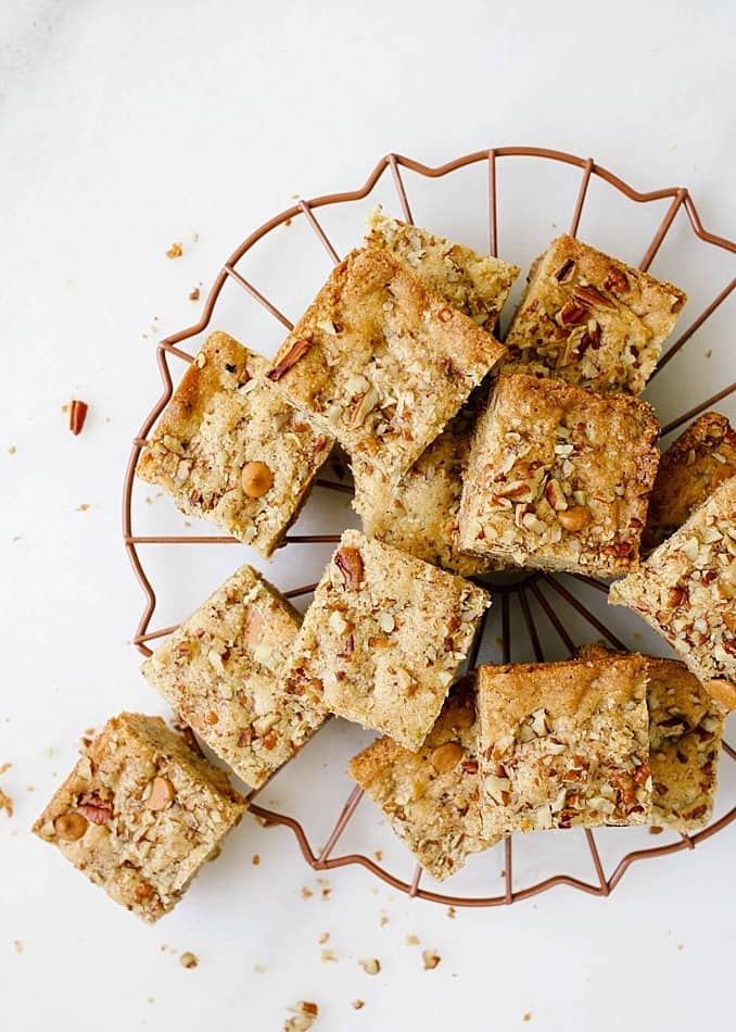 Butterscotch Blondies by the Wood and Spoon blog by Kate Wood. These are simple rich, and easy blondies made with brown sugar, pecans, and butterscotch chips. The caramel taste in these bars are crowd pleasers and perfect for sharing with a group of people. The recipe bakes quickly in a brownie pan and can be frozen and made ahead. Find the recipe for these nutty blondies on thewoodandspoon.com