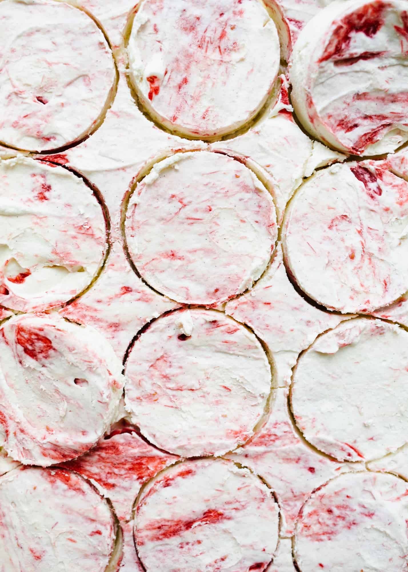 Sugar Cookie Ice Cream Sandwiches with Raspberry Ripple Ice Cream by Wood and Spoon blog. This is Sarah Keiffer's recipe for chewy sugar cookies loaded with no-sugar raspberry swirl ice cream. The ice cream is simple to put together and requires no ice cream machine. These are delicious frozen desserts! Makes enough jumbo treats to share with a crowd and is perfect for summer days! Find the recipe on thewoodandspoon.com