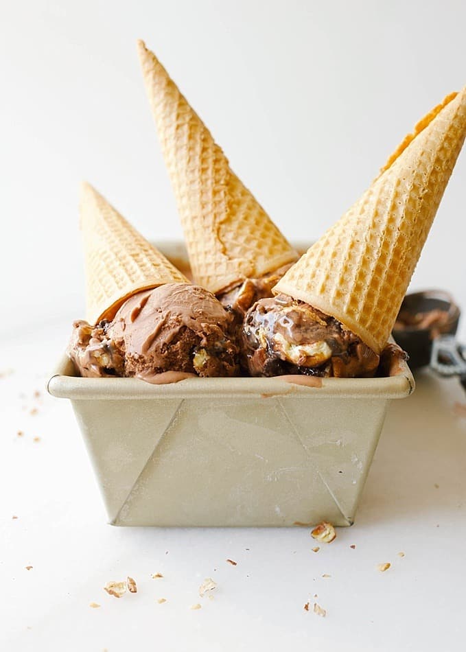 Turtle Ice Cream by The Wood and Spoon Blog by Kate Wood. This is a creamy chocolate ice cream adapted from jenny Britton Bauer, swirled with salted caramel sauce, hot fudge, and toasted pecans. This ice cream is super creamy, rich, sweet and salty. The toasted nuts add crunch that makes this ice cream a simple delicious homemade treat. Find the recipe on thewoodandspoon.com