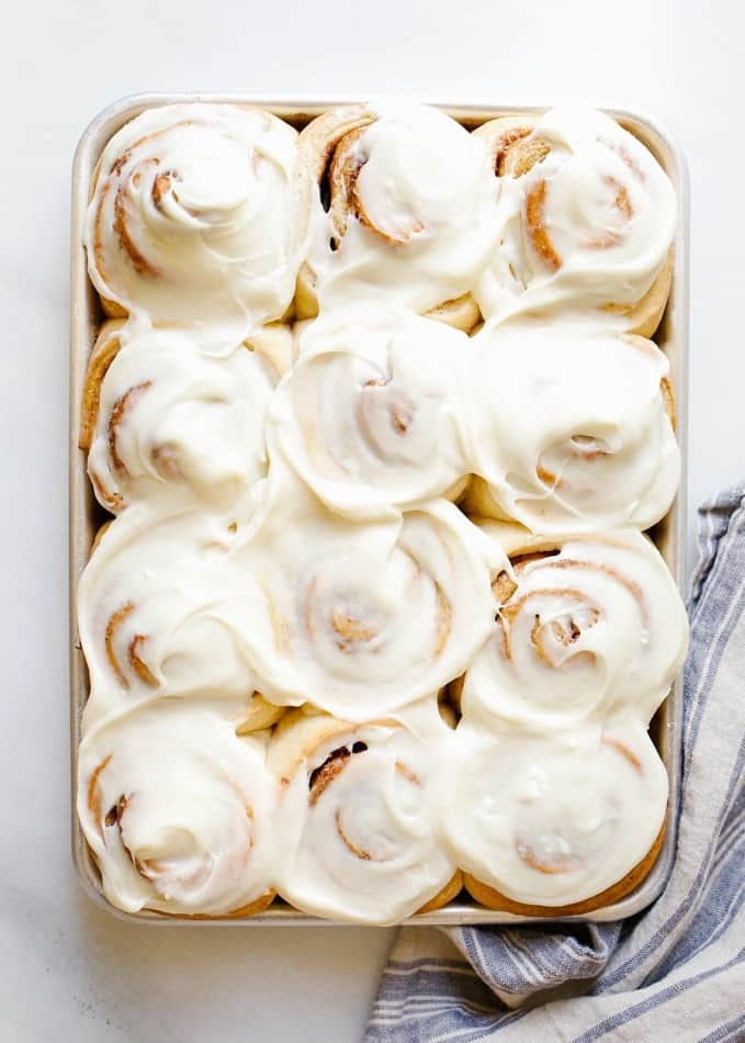 Overnight Cinnamon Rolls by Wood and Spoon. These are fluffy brown sugar and spice morning buns topped with a cream cheese frosting. The yeast dough can be prepped ahead of time, rolled, and left to rest in the fridge until baking time the following morning. This recipe makes delicious breakfast treats a cinch and is perfect for holiday entertaining. Find the recipe and how to for these pastries on thewoodandspoon.com by Kate Wood