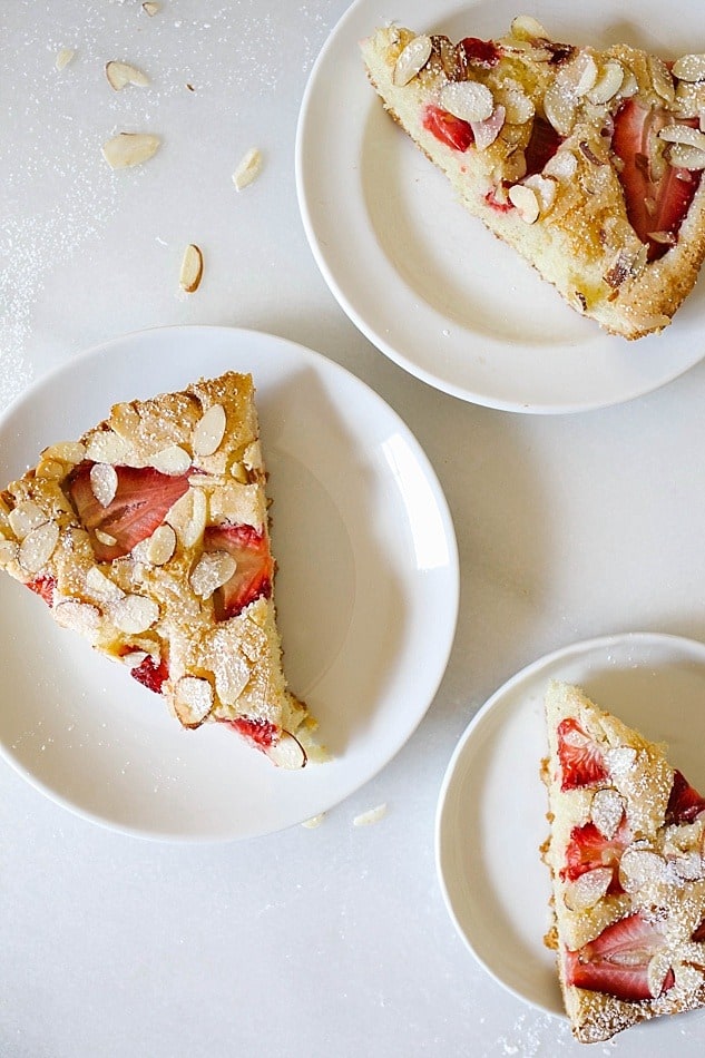 Strawberry Almond Skillet Cake Recipe A tangy, fluffy sour cream and vanilla cake baked in a cast iron skillet with juicy strawberries, sliced almonds, and a sprinkle of sugar. This is a simple, quick and fast recipe that is easy to put together and can be made ahead. This cake is served with whipped cream and is dusted with powdered sugar. Bake this Southern- style cake for summer parties, bbq, and gatherings. Substitute the sour cream with buttermilk if desired. Wood and Spoon Blog Recipe