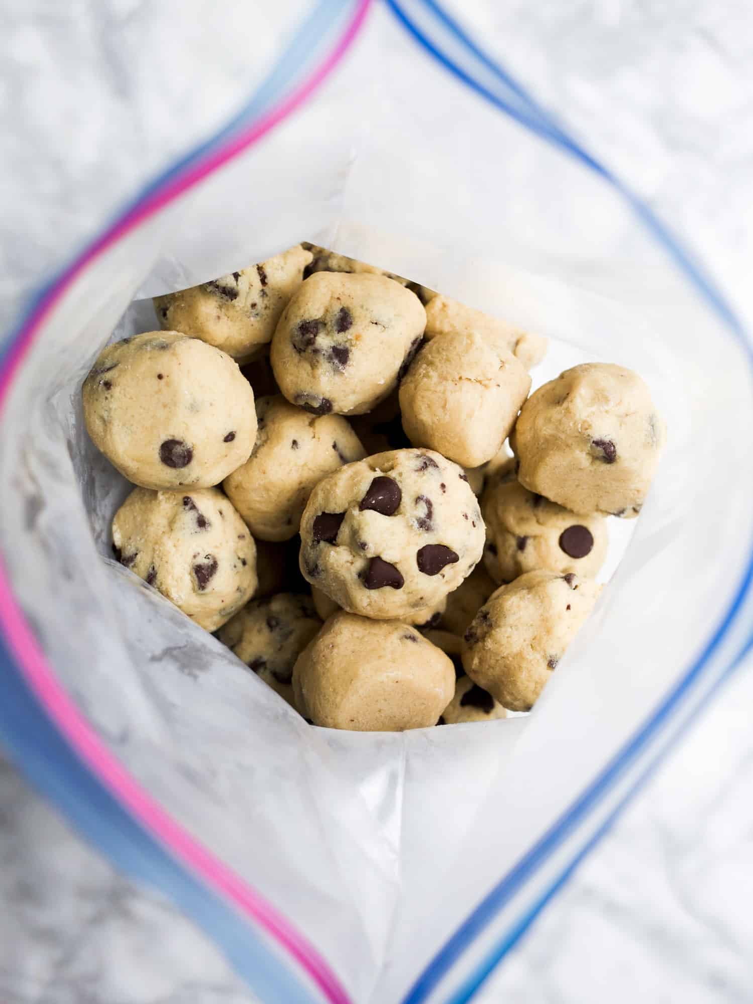 Freezer Cookie Dough Recipe by Wood and Spoon blog. This is a simple recipe for make-ahead cookie dough that bakes from frozen and can be stored in advance. Adapt the recipe to include your favorite chocolate, nuts, and other fillings. These cookie dough balls make a great gift to share with people and an excellent last-minute dessert! Learn how on thewoodandspoon.com.