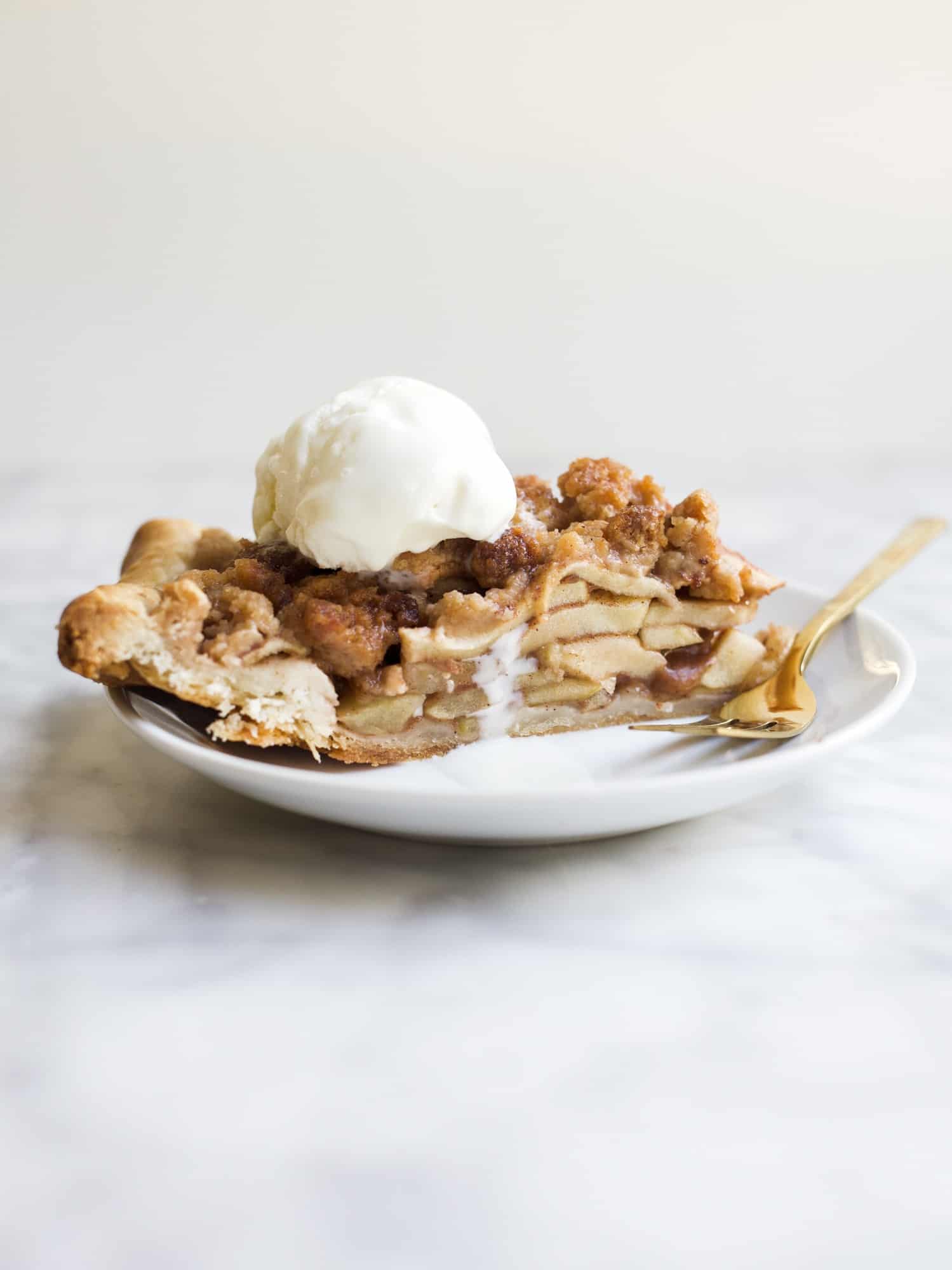 Dutch Apple Pie by Wood and Spoon Blog. This is a delicious fall pie made with homemade pie crust, cinnamon sugar apples and a streusel crumb topping. This pie is great for Thanksgiving or holidays and makes a yummy alternative for regular apple pie. Learn how to make homemade apple pie with brown sugar crumble on thewoodandspoon.com