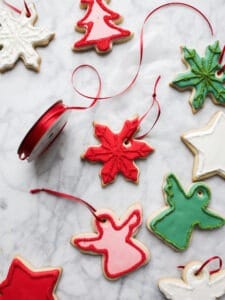 Sugar Cookie Ornaments by Wood and Spoon. These are a fun way to spruce up ordinary cookies around the holidays. This tutorial with photos shows how to hang sugar cookies on a string or ribbon to use as a decorative ornament. A soft butter sugar cookie is topped with royal icing makes a cute and decorative way to eat dessert. Learn how just in time for Christmas on thewoodandspoon.com