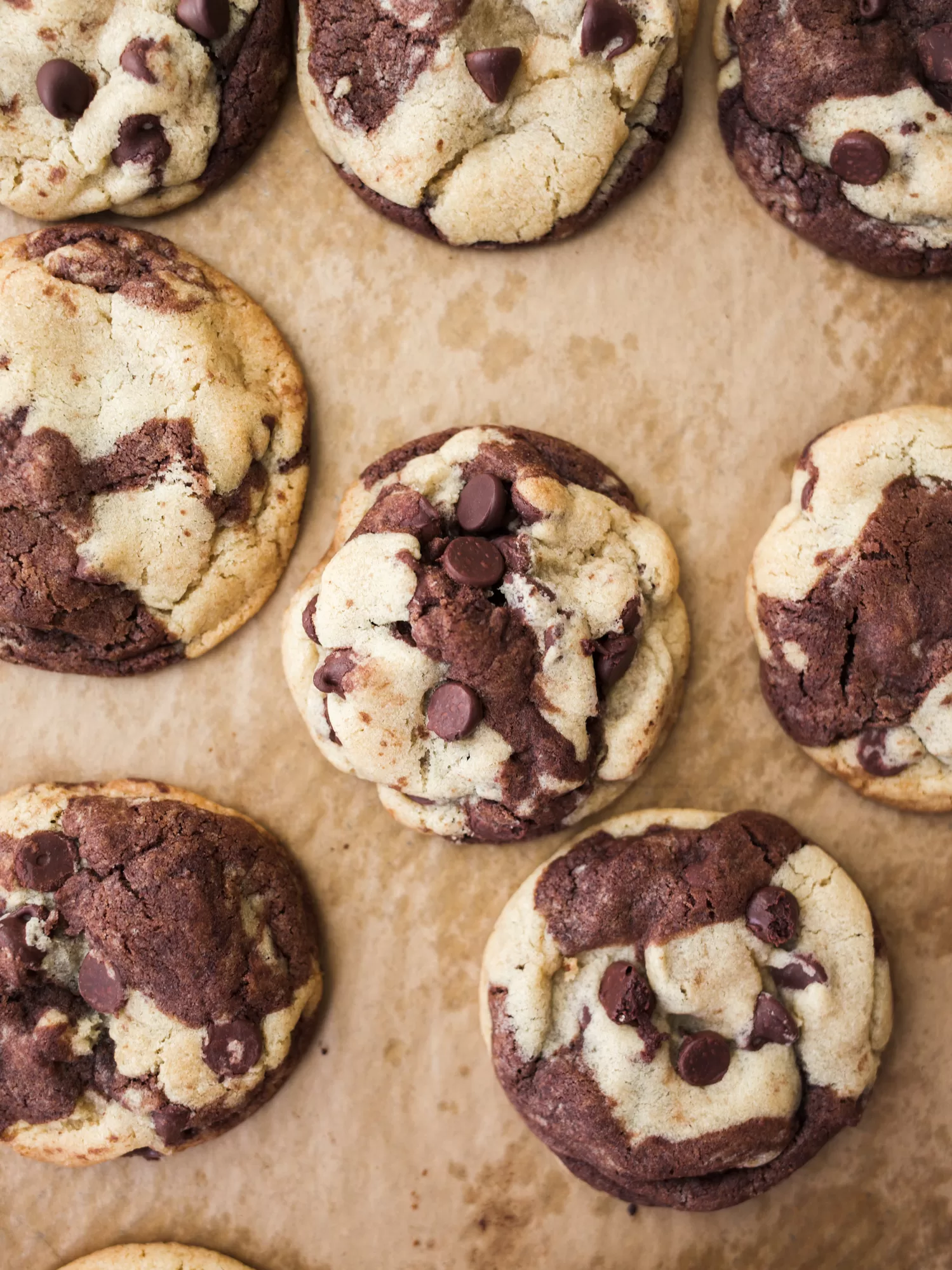 Marbled Chocolate Chip Cookies by Wood and Spoon blog. These are cookies made with a vanilla and a chocolate dough swirled together to make one marble cookie! These are great for people who love a little brownie and a little cookie! Find out how to make these make ahead desserts on thewoodandspoon.com.