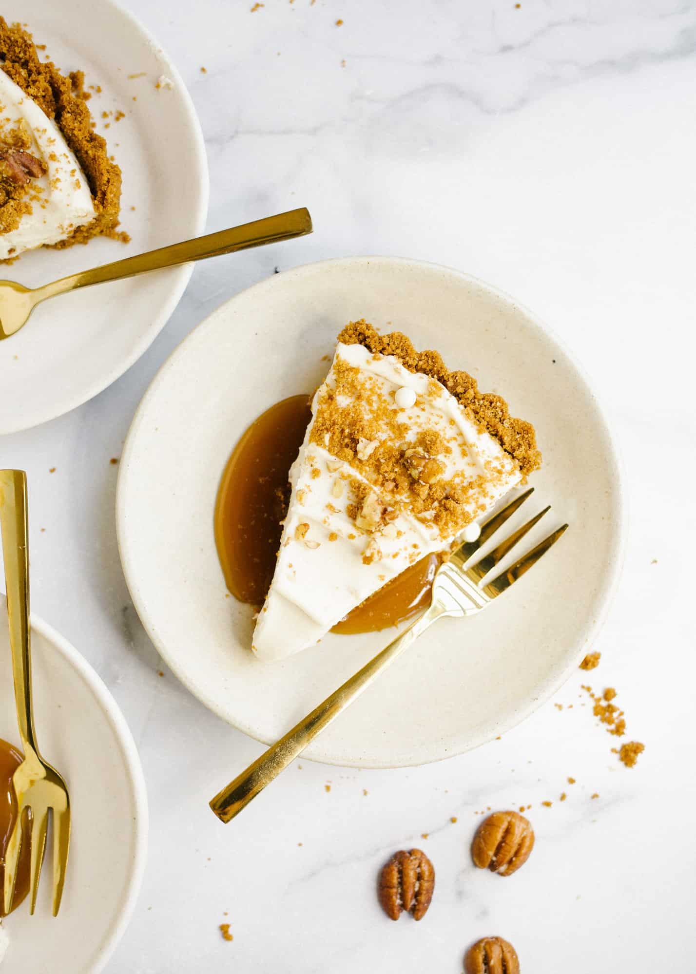 Maple Cream Tart by Wood and Spoon. This is a simple cream tart made with a biscoff cookie and pecan crust, a maple cream pie filling, and a homemade maple caramel. This sweet and salty holiday dessert can be made ahead and feeds a crowd. Learn how to make this beautiful fall dessert on thewoodandspoon.com