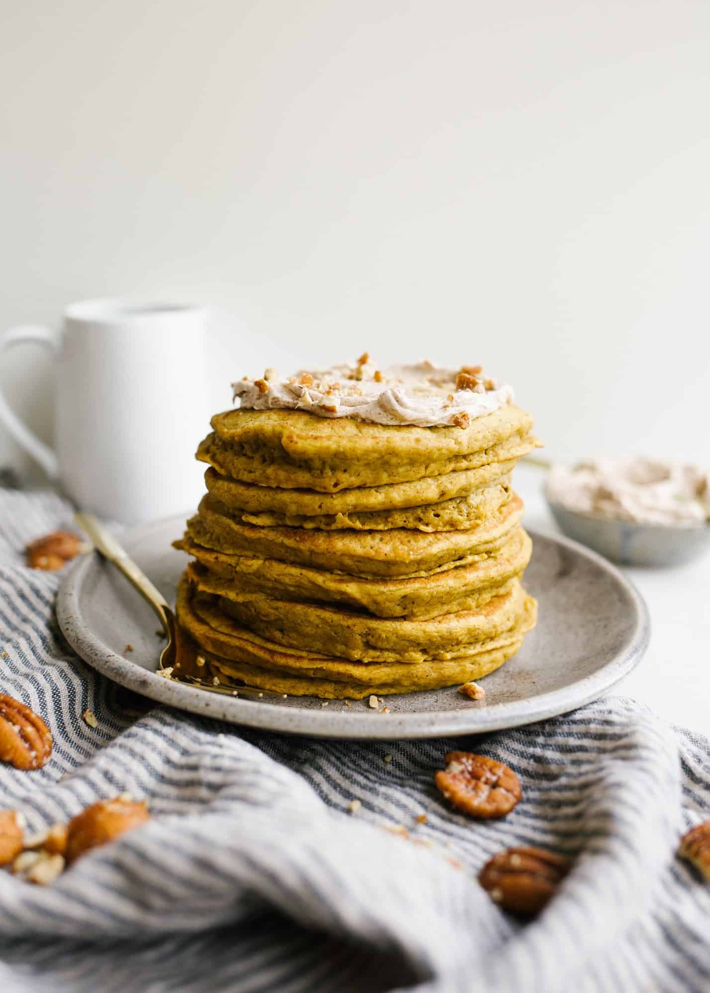 Pumpkin Pancakes with Whipped Cinnamon Butter by Wood and Spoon blog by Kate Wood. These are fluffy pancakes flavored with cinnamon and pumpkin puree. The pancakes are soft and tender and the butter is barely sweetened and scented with spice! Learn how simple these breakfast treats are to make this fall on thewoodandspoon.com