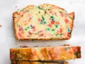 Funfetti Loaf by Wood and Spoon blog. This is a simple sprinkle quick bread made with butter and rainbow sprinkles. The batter comes together quickly to make a baked good that is great as dessert or breakfast. Learn how to make it on thewoodandspoon.com.