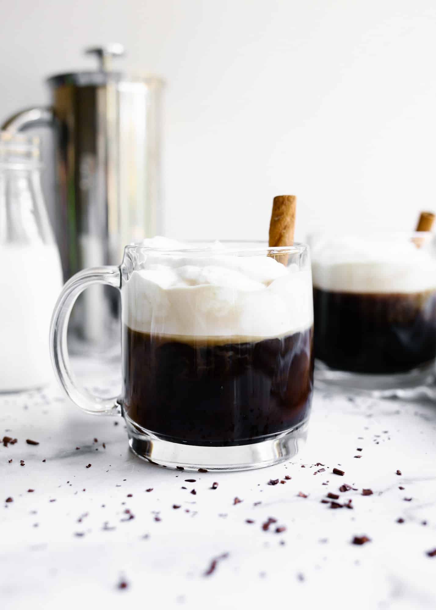 Kentucky Coffee by Wood and Spoon blog. This is a sweetened bourbon coffee topped with whipped cream and served warm as an after dinner beverage. Homemade whipped cream sweetens the coffee and added liquor provides an extra kick to the morning drink. Recipe found on thewoodandspoon.com